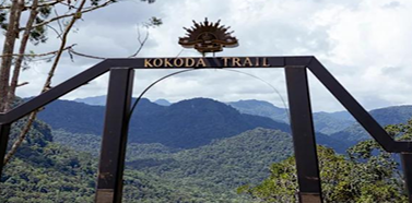 Kokoda Trail archway with jungle mountains behind