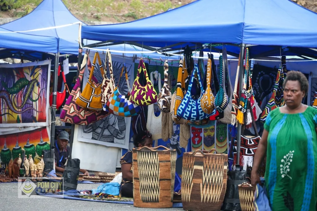 Craft market stalls with bilums and woven baskets